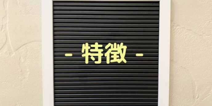 木目調の壁に掲げられた黒板に「特徴」と書かれたパネル