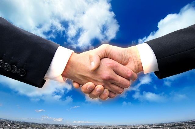 スーツ姿で握手する男性