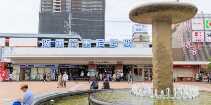 阪神電車尼崎駅の駅前広場と噴水、周囲の店舗と通行人のあるにぎやかな様子