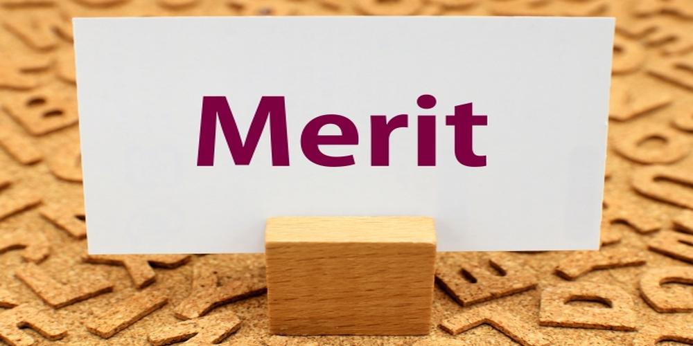 Meritの文字が印字された白いカードと木製スタンド