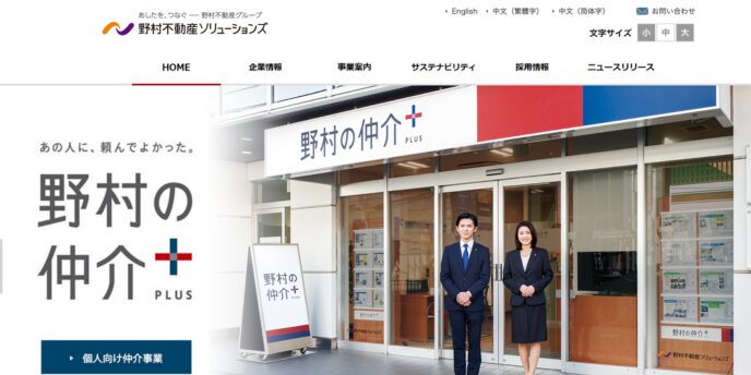野村の仲介プラス店舗前で佇むスタッフ